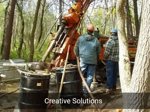 Men working on a drilling rig in the woods