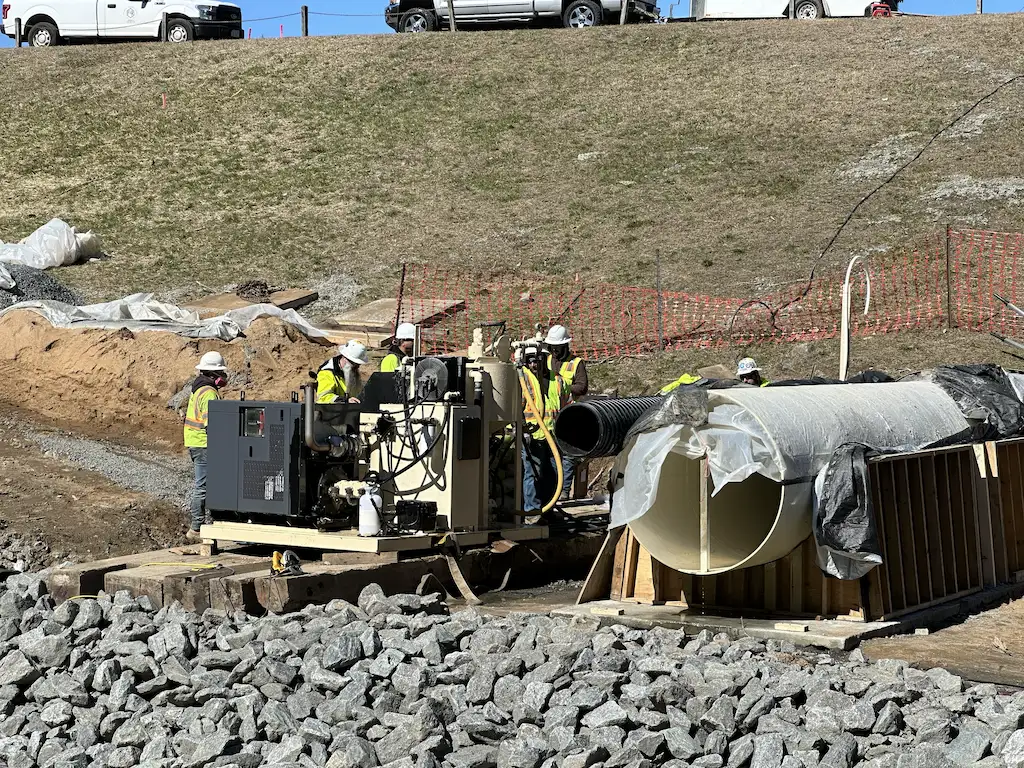 grout-mixer-project-angle - Pennsylvania Drilling Company wide angle shot of a dam abandonment project using our high shear colloidal grout mixer PD411